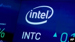 FILE - In this Oct. 1, 2019, file photo the symbol for semiconductor manufacturer Intel appears on a screen at the Nasdaq MarketSite, in New York.