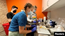 Medical staff prepare monkeypox vaccines at the Test Positive Aware Network nonprofit clinic in Chicago, July 25, 2022. 