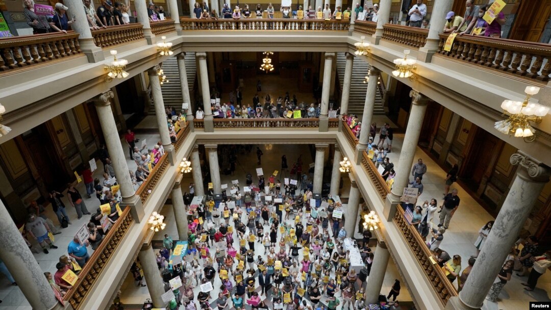 FILE - Activists protest in the Indiana Statehouse during a special session debating on banning abortion, in Indianapolis, Indiana, July 25, 2022.