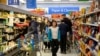 FILE - People shop at a Walmart Supercenter in Toronto, Ontario, Canada, March 13, 2020. Opposition parties in Canada say the government of Prime Minister Justin Trudeau is not doing enough to fight inflation.