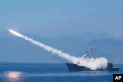 FILE - A Cheng Kung class frigate fires an anti-aircraft missile as part of a navy demonstration in Taiwan's annual Han Kuang exercises off the island's eastern coast near the city of Yilan, Taiwan, July 26, 2022.