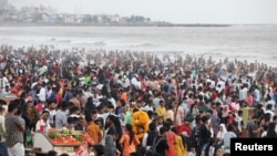 Visitors pack a crowded beach in Mumbai, India, June 12, 2022. The U.N.'s population projection predicts India will overtake China as the world's most populous country by next year. 