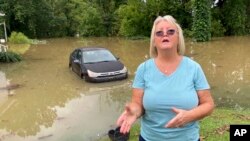 Patricia Colombo explains how she and her fiance took turns overnight watching the water line near his home in Jackson, Ky., July 29, 2022.