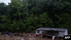 Puing-puing bangunan tampak berada di dekat salah satu rumah yang hancur diterjang banjir di wilayah Jackson, Kentucky, pada 31 Juli 2022. (Foto: AFP/Seth Herald)