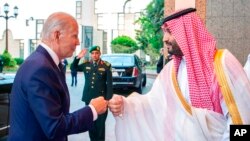 In this photo released by the Saudi Press Agency, Saudi Crown Prince Mohammed bin Salman greets President Joe Biden with a fist bump after his arrival in Jeddah, Saudi Arabia, July 15, 2022.