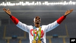 FILE - Britain's Mo Farah celebrates his win at the men's 5,000-meter medals ceremony, at the 2016 Summer Olympics in Rio de Janeiro, Brazil, Aug. 20, 2016. 