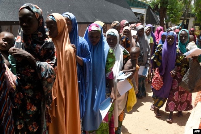 FILE - Mothers queue to be attended to with children that are suffering malnutrition in a clinic set up by health authorities in collaboraion with Medecins Sans Frontieres or Doctors Without Borders (MSF)in Katsina State, northwest Nigeria, on July 20, 2022. (Photo by PIUS UTOMI EKPEI / AFP)