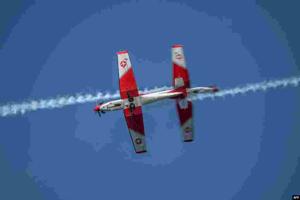 The Swiss Air Force PC-7 Team performs a show ahead of the final match of the Swiss Open tennis tournament in Gstaad, Switzerland.