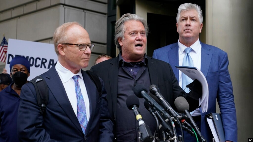 Former White House strategist Steve Bannon, center, speaks with members of the press after departing the federal court, July 18, 2022, in Washington. Standing with Bannon are his attorneys David Schoen, left, and M. Evan Corcoran. 