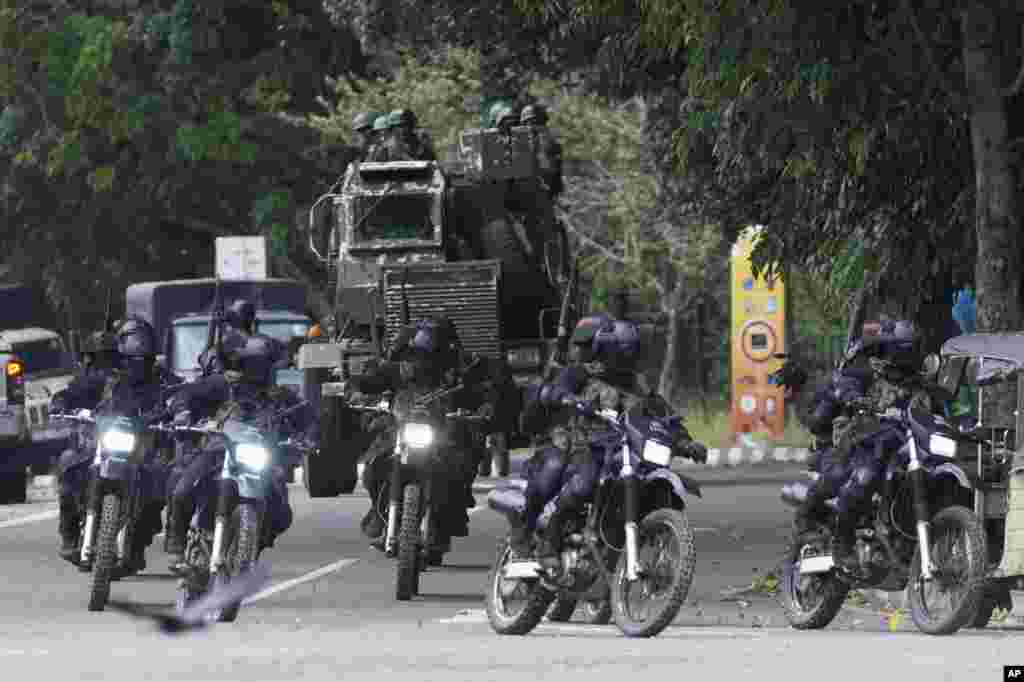Special force soldiers patrol a road that leads to the parliament in Colombo, Sri Lanka. Protesters began to retreat from government buildings they had seized and military troops reinforced security at the Parliament, establishing a tenuous calm in a country in both economic meltdown and political limbo.