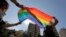FILE - Activists from the LGBTQ community in Lebanon shout slogans and hold up a rainbow flags as they march calling on the government for more rights in the country gripped by economic and financial crisis, June 27, 2020. 