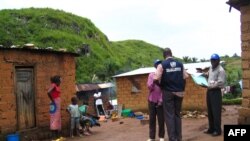 FILE - World Health Organization epidemic specialists visit a shanty town after an outbreak of the Marburg virus in Angola, April 10, 2005. Ghana recorded three cases of the virus in June 2022, but was declared free of Marburg on Sept. 16, 2022, a health official announced.