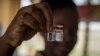 FILE — A nurse shows the Malaria vaccine Mosquirix at the Ewin Polyclinic in Cape Coast, Ghana, on April 30, 2019. 