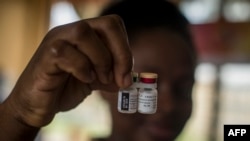 FILE: A nurse shows the Malaria vaccine Mosquirix at the Ewin Polyclinic in Cape Coast, Ghana, on April 30, 2019. - Ewim Polyclinic on April 30, 2019 was the first in Ghana to roll out the Malaria vaccine Mosquirix. Now twelve African nations will received millions of doses.