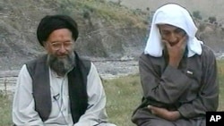 In this television image from Arab satellite station Al-Jazeera, Osama bin Laden, right, listens as his top deputy Ayman al-Zawahri speaks at an undisclosed location, in this image made from undated video tape broadcast by the station April 15, 2002.(AP P