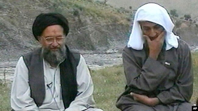 In this television image from Arab satellite station Al-Jazeera, Osama bin Laden, right, listens as his top deputy Ayman al-Zawahri speaks at an undisclosed location, in this image made from undated video tape broadcast by the station April 15, 2002.(AP P