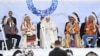 FILE - Pope Francis, center, speaks to members of the Indigenous community at Muskwa Park in Maskwacis, Alberta, July 25, 2022. 