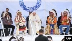FILE - Pope Francis, center, speaks to members of the Indigenous community at Muskwa Park in Maskwacis, Alberta, July 25, 2022. 