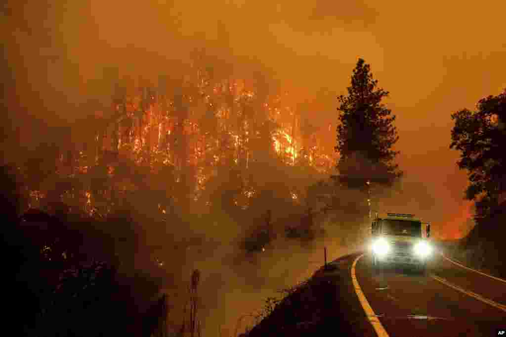 A firetruck drives along California Highway 96 as the McKinney Fire burns in Klamath National Forest, California, July 30, 2022.
