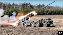 This handout photo taken from video released by the Russian Defense Ministry Press Service, July 15, 2022, shows the Russian military's Uragan multiple rocket launcher firing rockets at Ukrainian troops at an undisclosed location.