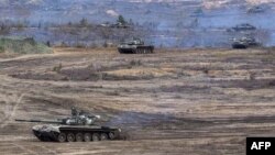 This handout video grab released by the Russian Defense Ministry on Feb. 21, 2022, shows Russian and Belarus tanks during joint exercises near Brest, Belarus.