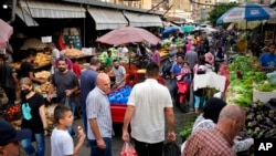 People shop at a popular market in Beirut, Lebanon, July 15, 2022.