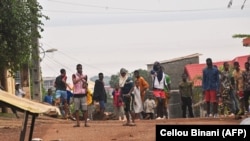 FILE: Protesters block roads and hurl rocks in Conakry on July 28, 2022, after authorities prevented supporters of the opposition party, National Front for the Defence of the Constitution (FNDC), from gathering in the streets for a peaceful march.