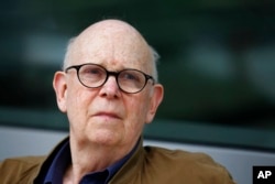 FILE - Pop artist Claes Oldenburg watches as his sculpture "Paint Torch" is installed by the George Young Company at the Pennsylvania Academy of the Fine Arts in Philadelphia, Aug. 20, 2011.