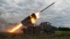 Ukrainian servicemen fire with a BM21 Grad multiple launch rocket system in a frontline in Kharkiv region, as Russia's attack on Ukraine continues, Aug. 2, 2022. 