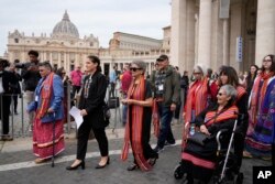 FILE - President of the Metis community, Cassidy Caron, second left, and other delegates arrive to speak to the media in St. Peter's Square, March 28, 2022. Pope Francis travels to Canada, beginning July 24, to apologize for the horrors of church-run Indi