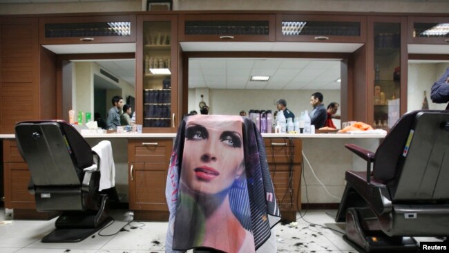 FILE - The morals police seal off a barber shop for giving Western-style haircuts in Tehran, June 16, 2008.
