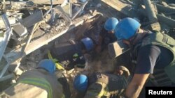 Rescuers release a man from the ruins of a residential building destroyed by a Russian military strike in the town of Toretsk, Donetsk region, Ukraine July 18, 2022, in this photo released by the State Emergency Service of Ukraine.