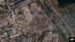 This satellite image from Planet Labs PBC shows the aftermath of a Ukrainian strike on a Russian ammunition depot in Nova Kakhovka, Ukraine, July 12, 2022. 