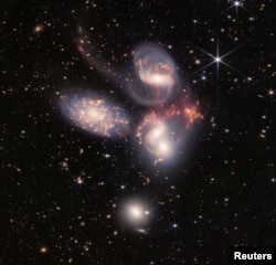 In this image produced by NASA's James Webb Space Telescope, a group of five galaxies that appear close to each other in the sky are shown: two in the middle, one toward the top, one to the upper left, and one toward the bottom. (Image Credit: NASA, ESA, CSA, STScI, Webb ERO Production Team/Handout via REUTERS)