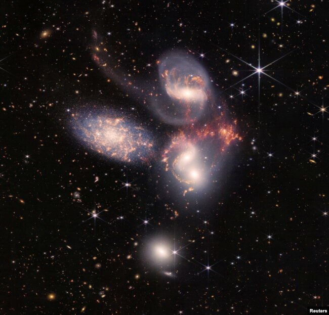 In this image produced by NASA's James Webb Space Telescope, a group of five galaxies that appear close to each other in the sky are shown: two in the middle, one toward the top, one to the upper left, and one toward the bottom. (Image Credit: NASA, ESA, CSA, STScI, Webb ERO Production Team/Handout via REUTERS)