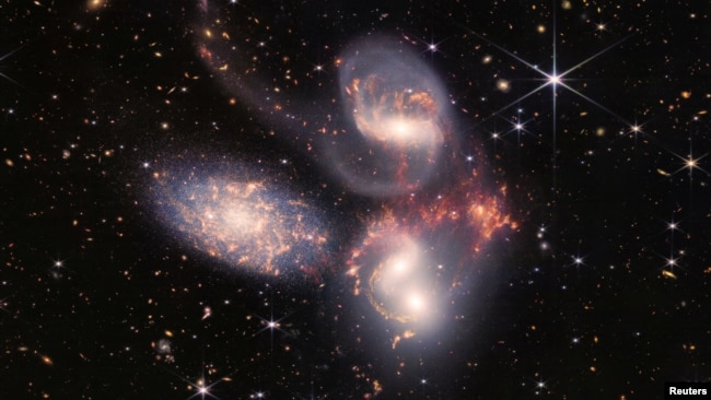 In this image produced by NASA's James Webb Space Telescope, a group of five galaxies that appear close to each other in the sky are shown: two in the middle, one toward the top, one to the upper left, and one toward the bottom. (Image Credit: NASA, ESA,