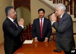 FILE - In this photograph provided by the Sri Lankan President's Office, acting President Ranil Wickremesinghe, right, greets Chief Justice Jayantha Jayasuriya during the oath-taking ceremony in Colombo, Sri Lanka, Friday, July 15, 2022.