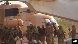 FILE: This undated photograph handed out by French military shows Russian mercenaries boarding a helicopter