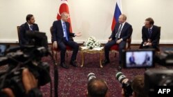 FILE - This handout photo taken and released on July 19, 2022, shows Turkish President Recep Tayyip Erdogan (L) talking with Russian President Vladimir Putin during a meeting as part of the Astana Trilateral Summit in Tehran, Iran. (Turkish Presidential Press Service)