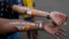 Girls display their arms painted with message "Ranil go home' referring to Prime Minister Ranil Wickremesinghe at the protest site in Colombo, Sri Lanka, July 17, 2022. 