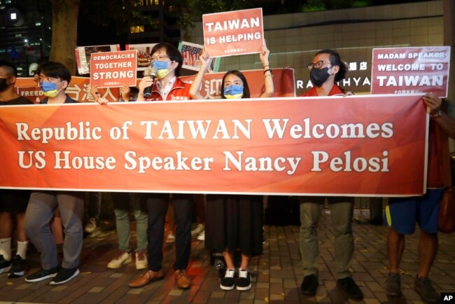 Supporters hold a banner outside the hotel where U.S. House Speaker Nancy Pelosi is supposed to be staying in Taipei, Taiwan, Tuesday, Aug 2, 2022. U.S. House Speaker Nancy Pelosi was believed headed for Taiwan on Tuesday on a visit that could significantly escalate tensions with Beijing, which claims the self-ruled island as its own territory. (AP Photo/Chiang Ying-ying)