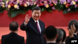 FILE - China's President Xi Jinping waves following his speech after a ceremony to inaugurate the city's new leader and government in Hong Kong on July 1, 2022.