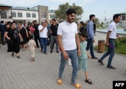 People tour the newly rebuilt village of Agali in the district of Zangilan, Azerbaijan, July 19, 2022.