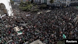 People gather during a protest over President Abdelaziz Bouteflika's decision to postpone elections and extend his fourth term in office, in Algiers, Algeria, March 15, 2019. 
