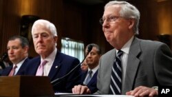 FILE - Sen. Ted Cruz, R-Texas, left, Senate Majority Whip Sen. John Cornyn, R-Texas, and Senate Majority Leader Mitch McConnell of Ky., testify in favor of ambassador nominees during a Senate Foreign Relations Committee hearing.