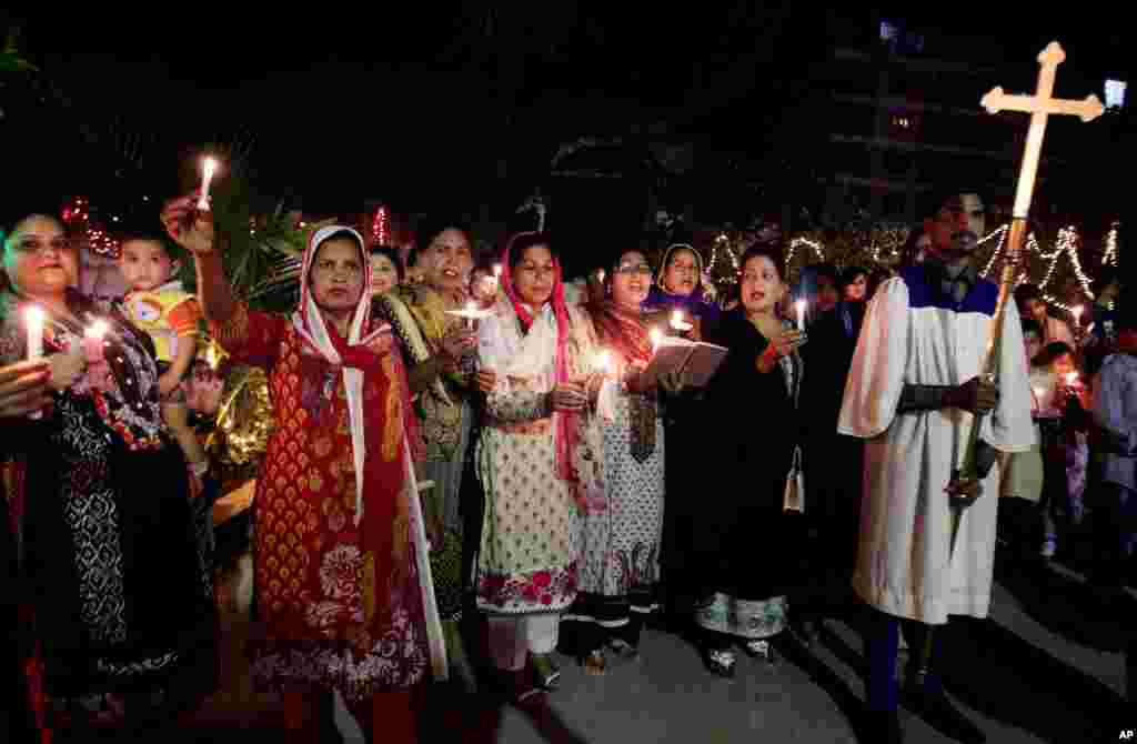 Pakistani Christians chant prayers during Easter service in Karachi, April 5, 2015.