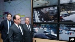 Prezidan Fransè a, Francois Hollande, nan mitan, pandan li tap vizite Direksyon Polis Pari a, ansanm ak Minis Enteryè a, Matthias Fekl agoch, ak Prefè Pari a Michel Delpuech, yon jou apre atak teworis la toupre Champs-Elysees. (Foto: Philippe Wojazer Pool / AP). Pari, Frans, 21 april 2017.
