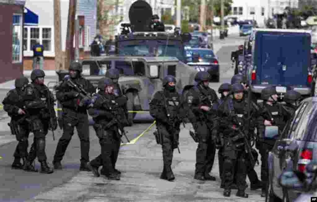 Heavily armed police continue to patrol the neighborhoods of Watertown, Mass. April 19, 2013