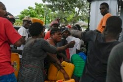 People line up to buy gasoline in Port-au-Prince, Haiti, Monday, July 12, 2021.
