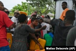 People line up to buy gasoline in Port-au-Prince, Haiti, Monday, July 12, 2021.
